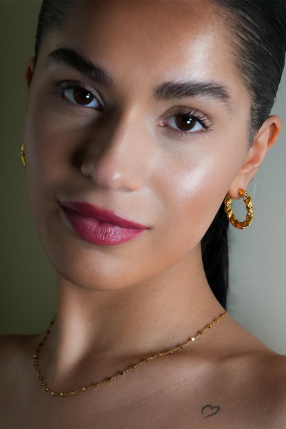 Style KAMENZ: Twisted Textured Hoop Earrings with Zirconia Embellishments.