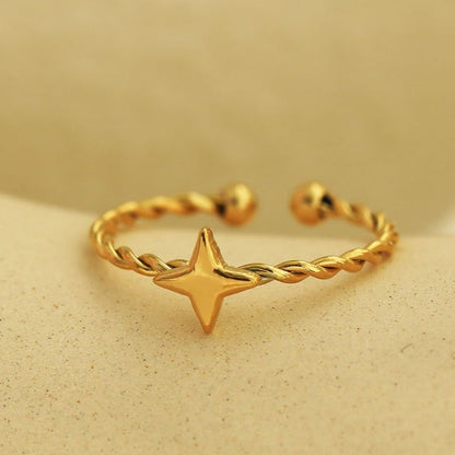 NICOLE Gold: Textured Ring with a Four Point Star Centre Piece
