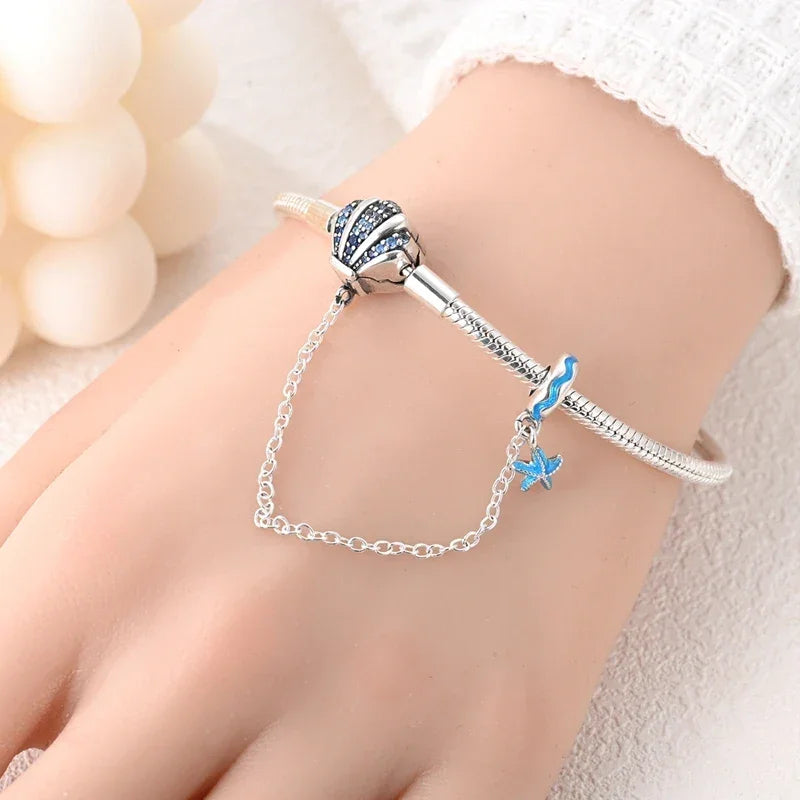 Sterling Silver Seashell Charm Bracelet with Blue CZ Gradient